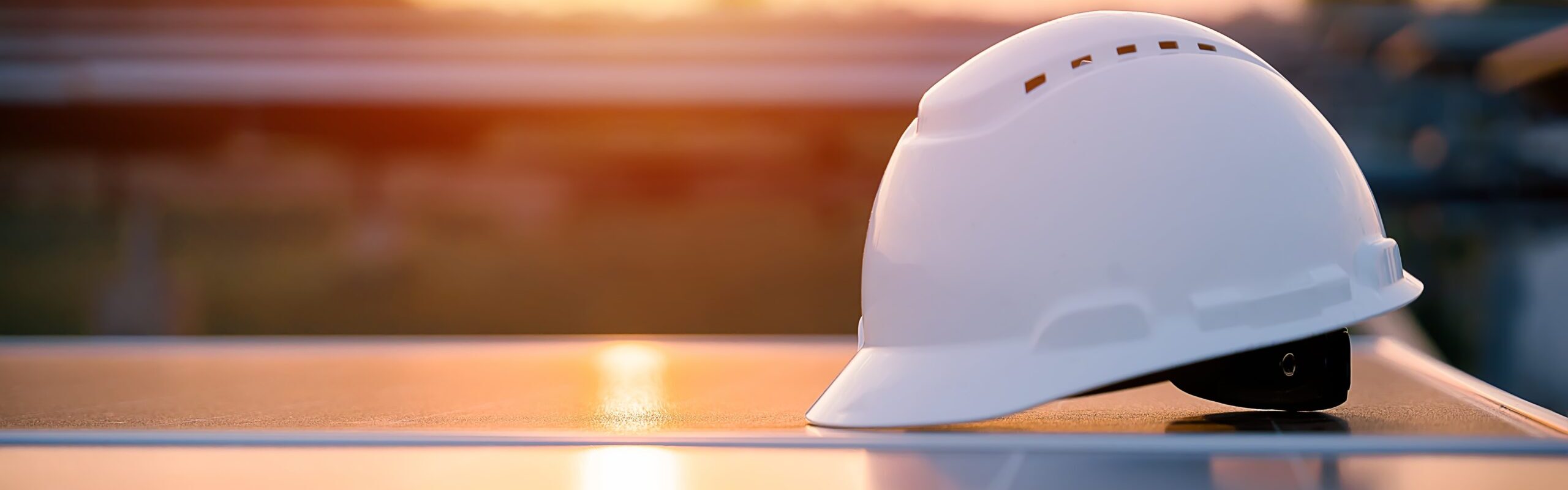 White,Safety,Hat,Placed,On,Solar,Panels,With,Sunset,In